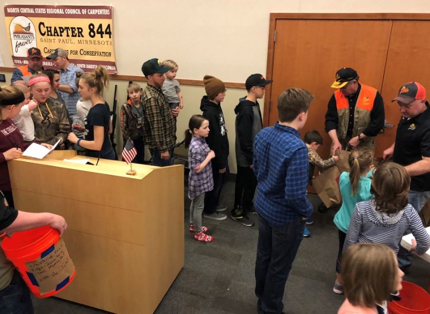 Youth lined up for a grocery grab bag of hunting and outdoor related goodies.