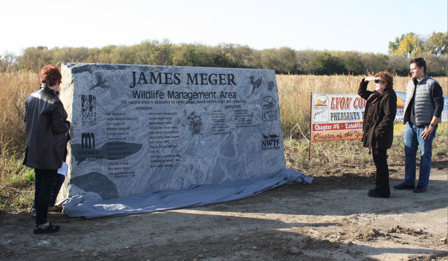 James Meger's family admire the stone monolith erected on the WMA's east side.