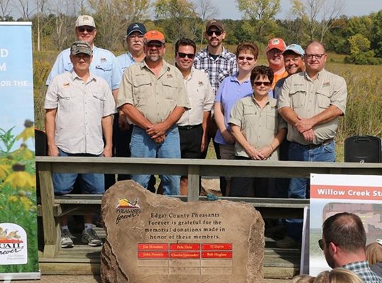 Pheasants Forever volunteers celebrate the dedication of the Willow Creek State Habitat Area in Edgar County, Ill.