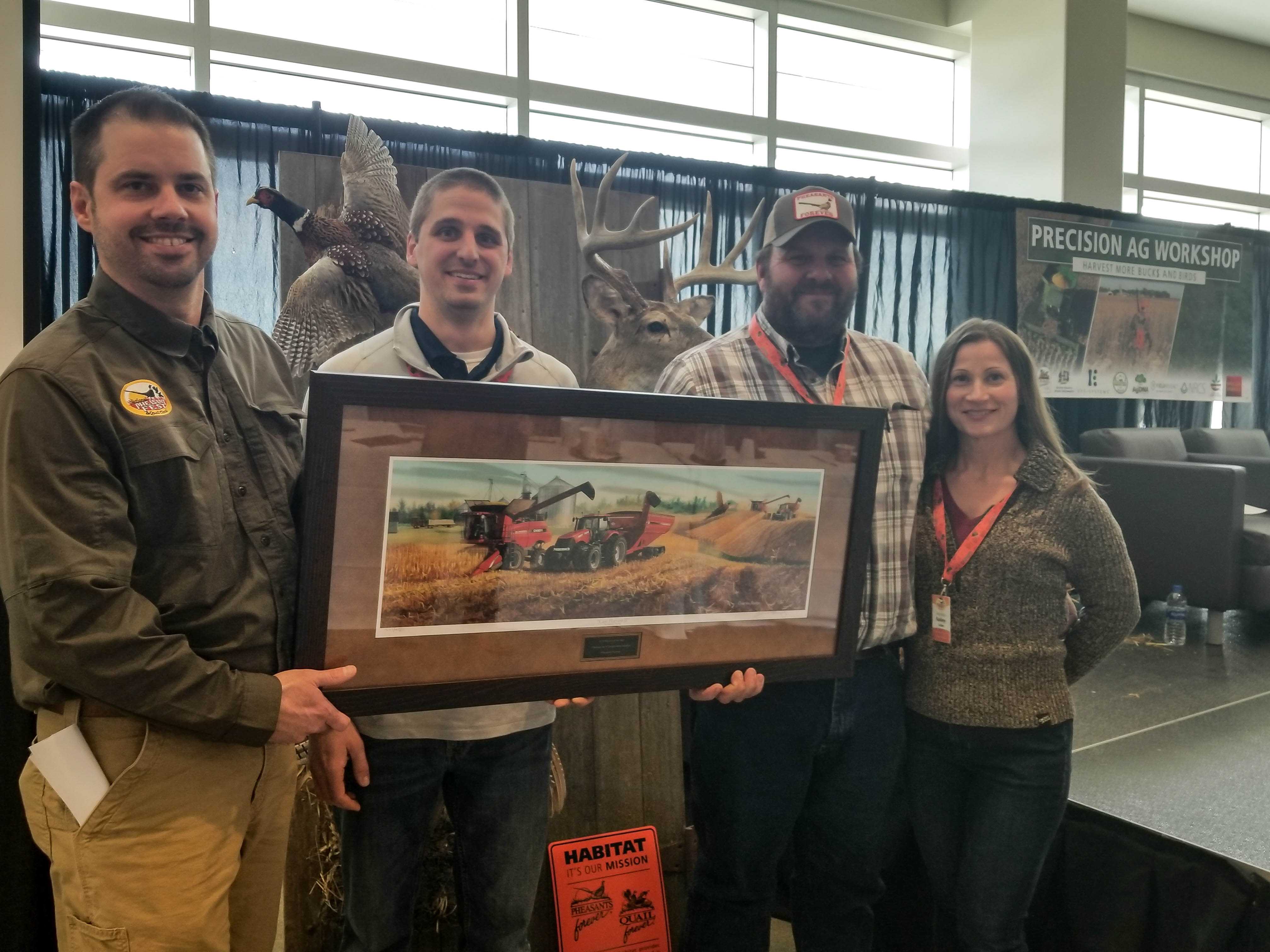 Jeff and Kelly Lake, at right, accept the Precision Ag Farmer of the Year Award from Pheasants Forever's Ryan Heiniger and Scott Stipetich, at left.