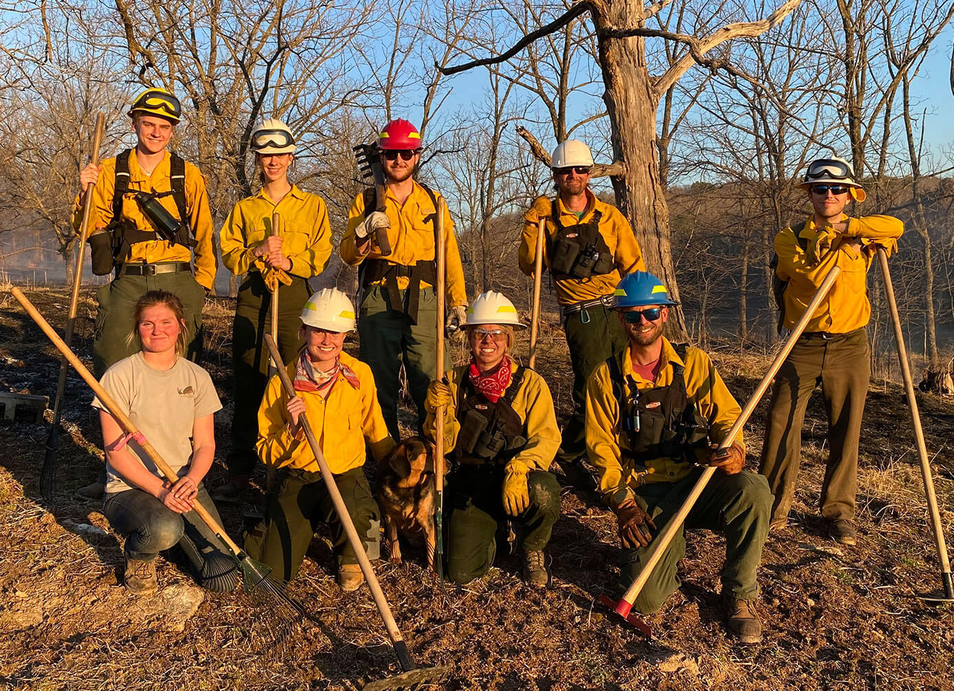 Burn workers posing in field after burn event