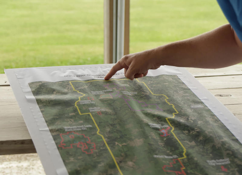 Hand pointing to location on map